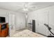 Bedroom with doors to other rooms, TV, and mini fridge with a comfortable bed at 4201 Sunrise Ave, Las Vegas, NV 89110