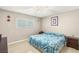 Comfortable bedroom showcasing a patterned blue comforter, ceiling fan, and window providing natural light at 4201 Sunrise Ave, Las Vegas, NV 89110
