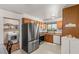 Kitchen featuring stainless steel appliances and wood cabinets with view into laundry room at 4201 Sunrise Ave, Las Vegas, NV 89110