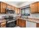 Kitchen featuring stainless steel appliances and wood cabinets with a window above sink at 4201 Sunrise Ave, Las Vegas, NV 89110