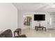 Bright living room showing a TV, white door, and an entrance into another room at 4201 Sunrise Ave, Las Vegas, NV 89110