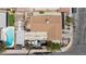 Aerial view of a single-Gathering home featuring a backyard pool, lawn and a detached garage plus street view at 4606 Powell Ave, Las Vegas, NV 89121