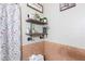 Charming bathroom with decoratively tiled walls, industrial style shelves, and a floral print shower curtain at 4606 Powell Ave, Las Vegas, NV 89121
