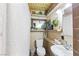Bathroom featuring ceramic tile walls and floor, a toilet, sink, and mirror with surrounding decor at 4606 Powell Ave, Las Vegas, NV 89121