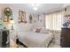 Comfortable bedroom featuring neutral tones, natural lighting and decorative wall art at 4606 Powell Ave, Las Vegas, NV 89121