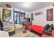 A bedroom featuring a red twin-size bed and an assortment of framed Spiderman pictures on the walls at 4606 Powell Ave, Las Vegas, NV 89121