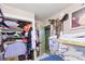 A closet featuring shelves and hanging clothes and a variety of boxes and personal items at 4606 Powell Ave, Las Vegas, NV 89121