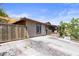Long driveway leading to a single-story home with gated front entry, and landscaped surroundings at 4606 Powell Ave, Las Vegas, NV 89121