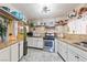 Well-lit kitchen with stainless steel appliances, granite countertops, and ample storage space at 4606 Powell Ave, Las Vegas, NV 89121