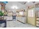 Charming kitchen with white cabinets, granite countertops, and a decorative accent over the oven and cooktop at 4606 Powell Ave, Las Vegas, NV 89121