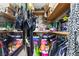 Walk-in closet featuring a variety of clothes, handbags, and shelf storage options at 4606 Powell Ave, Las Vegas, NV 89121