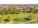 The aerial view shows a golf course community with mature trees and a green landscape; this house is in a beautiful location at 4856 Fiesta Lakes St, Las Vegas, NV 89130