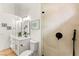 Bright bathroom featuring a white vanity, arched mirrors, and a glass-enclosed shower at 4856 Fiesta Lakes St, Las Vegas, NV 89130