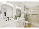 Bathroom featuring a double vanity, framed mirrors, and a glass-enclosed shower at 4856 Fiesta Lakes St, Las Vegas, NV 89130