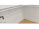 Spacious, well-lit walk-in closet with white shelving and wood flooring at 4856 Fiesta Lakes St, Las Vegas, NV 89130