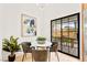 Cozy breakfast nook with modern table and chairs, bathed in natural light from a large window at 4856 Fiesta Lakes St, Las Vegas, NV 89130
