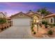 Charming single-story home with a well-manicured front yard and a two car garage at 4856 Fiesta Lakes St, Las Vegas, NV 89130