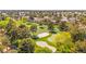 The image showcases a green golf course with sand traps and trees in a well-maintained community at 4856 Fiesta Lakes St, Las Vegas, NV 89130