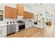 Open concept kitchen with stainless steel appliances, white countertops, and modern cabinetry at 4856 Fiesta Lakes St, Las Vegas, NV 89130