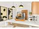 Stylish kitchen island with bar seating, modern pendant lights, and wooden cabinets at 4856 Fiesta Lakes St, Las Vegas, NV 89130
