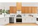 Bright kitchen featuring stainless steel appliances, white countertops, and stylish wood and white cabinetry at 4856 Fiesta Lakes St, Las Vegas, NV 89130