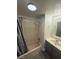 A bathroom featuring a tub/shower combo with gray curtain and a vanity with gray cabinets at 4941 Newport Cove Dr # B, Las Vegas, NV 89119