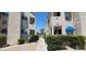 Exterior shot showing a walkway through the condos complex and landscaped grounds at 4941 Newport Cove Dr # B, Las Vegas, NV 89119