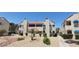 Charming two-story condo with adobe-style facade, awnings, and landscaped front yard at 4941 Newport Cove Dr # B, Las Vegas, NV 89119