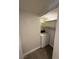 This well-lit laundry area includes shelving and a white washing machine at 4941 Newport Cove Dr # B, Las Vegas, NV 89119