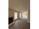 The open living room boasts wood-look flooring and sliding doors for seamless indoor-outdoor flow at 4941 Newport Cove Dr # B, Las Vegas, NV 89119