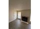 Cozy living room featuring a fireplace, wood-look flooring, and plenty of natural light at 4941 Newport Cove Dr # B, Las Vegas, NV 89119