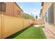 Low-maintenance backyard with artificial turf, offering a clean and green space at 5674 Moccasin Point St, Las Vegas, NV 89148