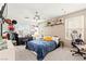 A comfortable bedroom with a ceiling fan, a plush bed, vanity area, and a relaxing seating area at 5674 Moccasin Point St, Las Vegas, NV 89148