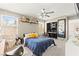 Inviting bedroom featuring a plush bed, large window, ceiling fan, and desk setup for work or study at 5674 Moccasin Point St, Las Vegas, NV 89148