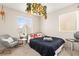 Bright bedroom with a comfortable bed and a relaxing sitting area at 5674 Moccasin Point St, Las Vegas, NV 89148