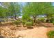 Community park with walking path and a variety of greenery and bushes at 5674 Moccasin Point St, Las Vegas, NV 89148