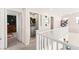 Upstairs hallway with laundry area, offering seamless access to bedrooms and other living spaces at 5674 Moccasin Point St, Las Vegas, NV 89148