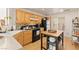 Well-lit kitchen with wooden cabinets, appliances, and a kitchen island at 5674 Moccasin Point St, Las Vegas, NV 89148