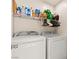 Functional laundry room with washer, dryer, and storage shelves at 5674 Moccasin Point St, Las Vegas, NV 89148