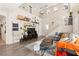 Bright, open living room featuring a staircase, hardwood floors, and large windows at 5674 Moccasin Point St, Las Vegas, NV 89148