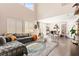 Bright, open living and dining area featuring hardwood floors and large windows at 5674 Moccasin Point St, Las Vegas, NV 89148