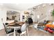 Open-concept living space featuring a dining area, staircase, comfortable seating, and abundant natural light at 5674 Moccasin Point St, Las Vegas, NV 89148