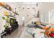 Bright, open living room featuring a staircase, hardwood floors, and large windows at 5674 Moccasin Point St, Las Vegas, NV 89148