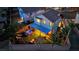 Enjoy this fully-fenced private backyard with a hot tub, covered patio, play area, and lush green turf at 6187 Novelty St, Las Vegas, NV 89148