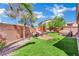 Beautifully landscaped backyard with lush lawn, seating area, and a relaxing hot tub at 6187 Novelty St, Las Vegas, NV 89148