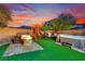 Charming backyard retreat with a hot tub, fire pit, play structure, and patio seating for relaxation and fun at 6187 Novelty St, Las Vegas, NV 89148