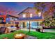 Inviting backyard with a hot tub, fire pit, and covered patio for outdoor living and entertaining at 6187 Novelty St, Las Vegas, NV 89148
