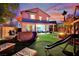 Enjoy the beautiful backyard featuring a covered patio, fire pit, and play area, perfect for Gathering fun at 6187 Novelty St, Las Vegas, NV 89148