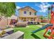 Expansive backyard featuring a lawn, patio, playset and hot tub perfect for outdoor entertaining at 6187 Novelty St, Las Vegas, NV 89148