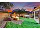 Cozy backyard featuring a fire pit, hot tub, and play area, ideal for relaxing and entertaining guests at 6187 Novelty St, Las Vegas, NV 89148
